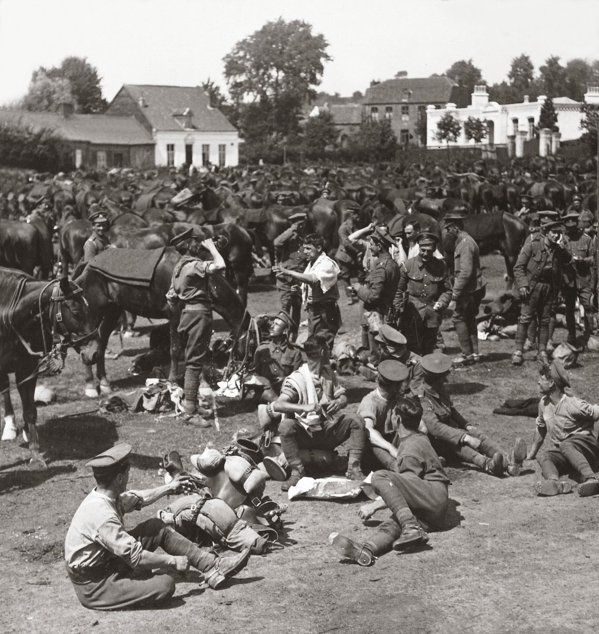 Cavalerie, altijd klaar in afwachting van een doorbraak, laten hun paarden rusten in een Frans dorp door English Photographer